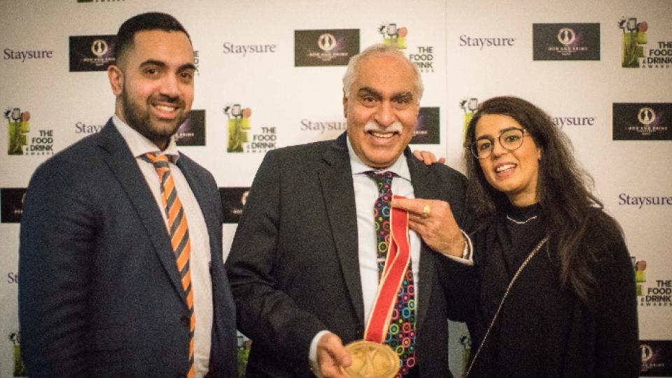 Members of the Anand family winning an award for best-family run restaurant.