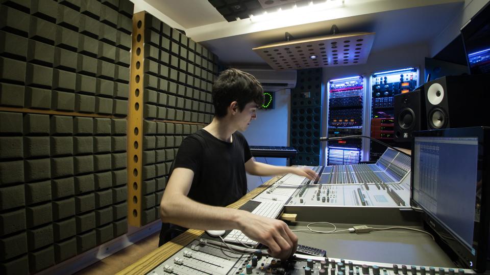 A student working at an LCM recording sound desk