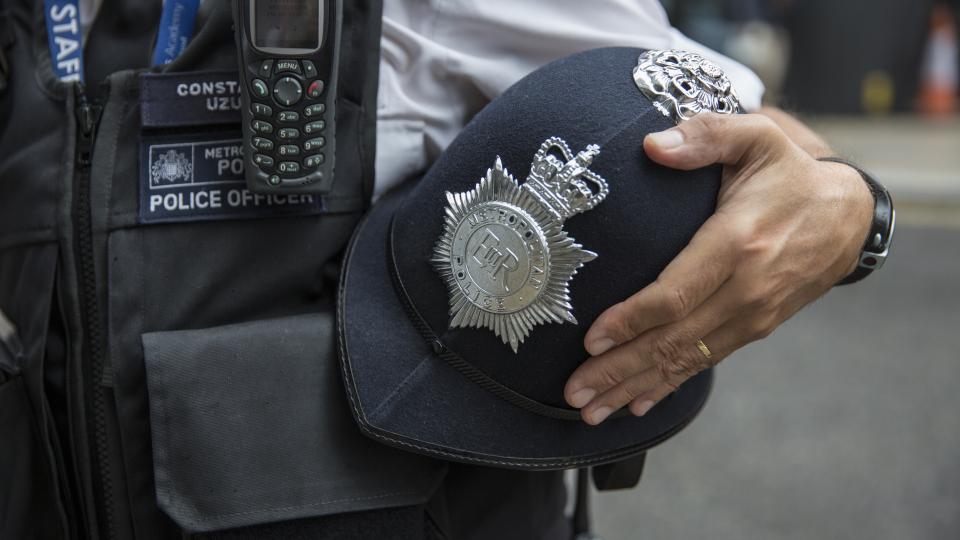 Police officer's hat under his or her arm.
