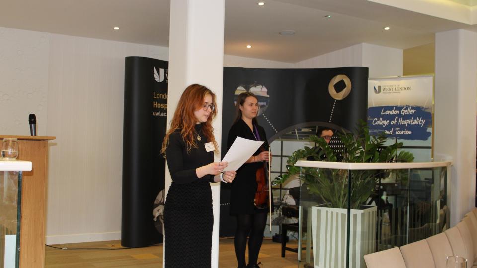 Megan Russell, Eduards Grieznis and Maryam Ahmed (students) on stage at the Donors and Scholars event in Pillars restaurant.