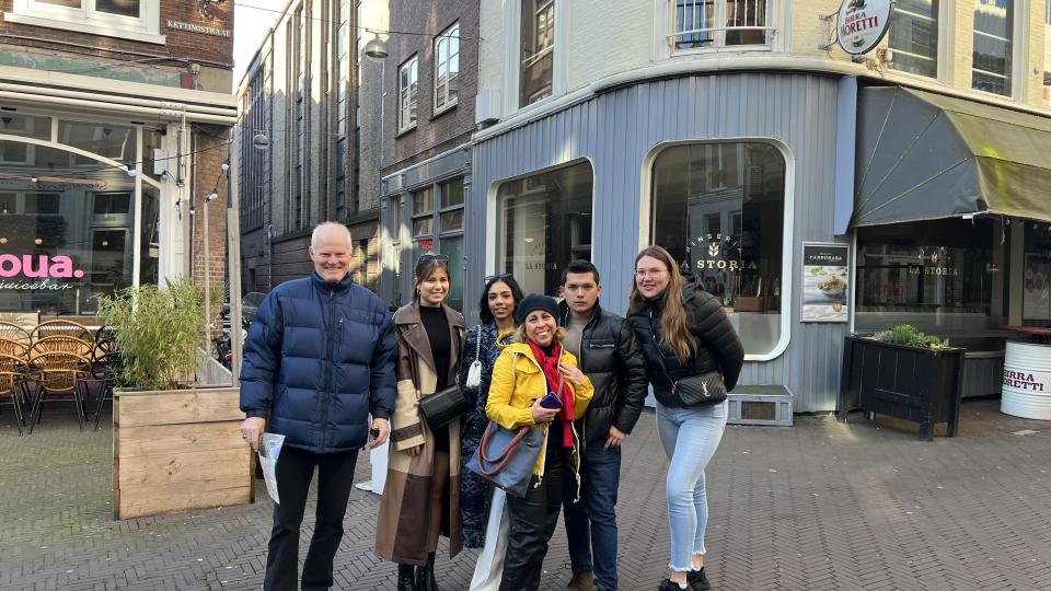 UWL law students and staff stood in front of a shopfront in Amsterdam