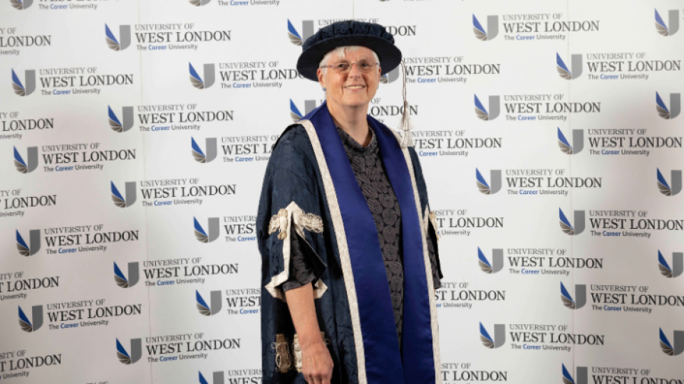 Honorary graduation, Jennifer Bernard, at UWL graduation 2023 smiling with her gown and hat on.