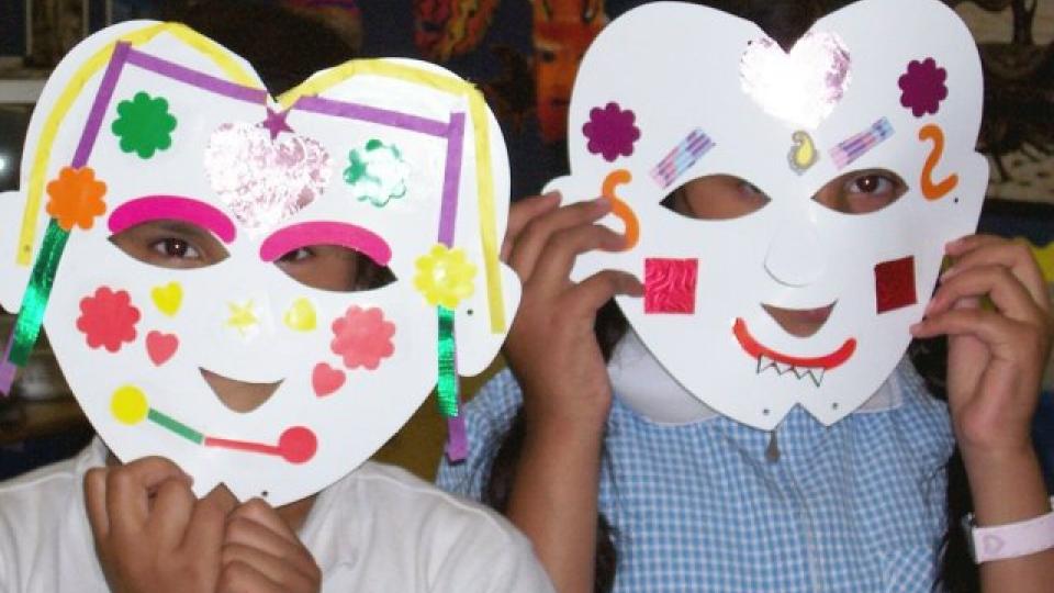Children wearing masks they made