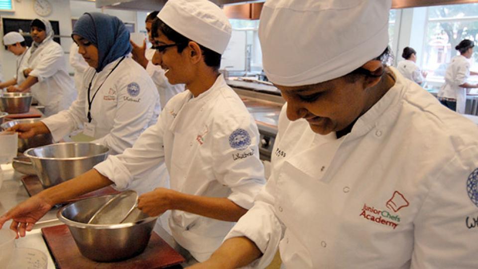 Young chefs in a kitchen at the Junior Chefs' Academy