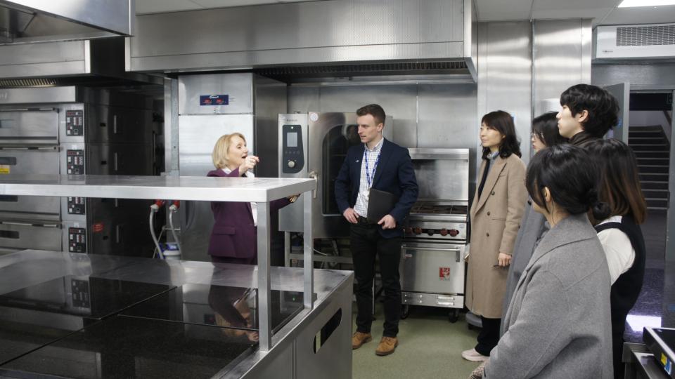 Five South Korean BioHealth Regulatory Science researchers with Sebastian Berg and Dr Amalia Tsiami inside the West London Food Innovation Centre (WLFIC)