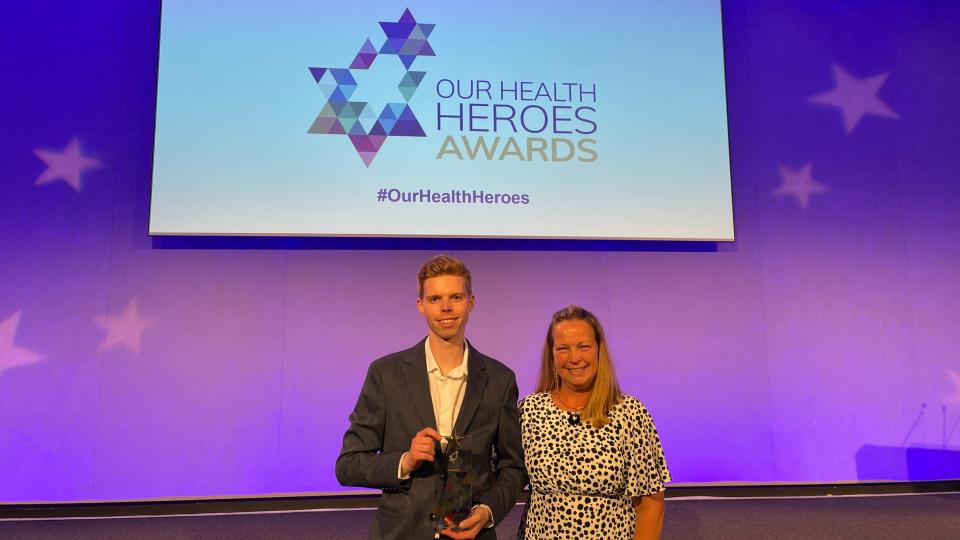 Joe Maslen holding award at the Our Health Heroes Apprentice of the Year awards