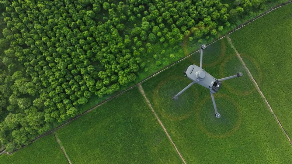 A Future Flight drone flying over a forest