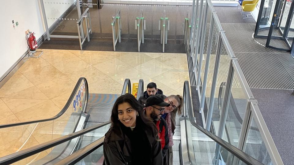 LSFMD Journalism students smiling on the escalators inside the Guardian headquarters