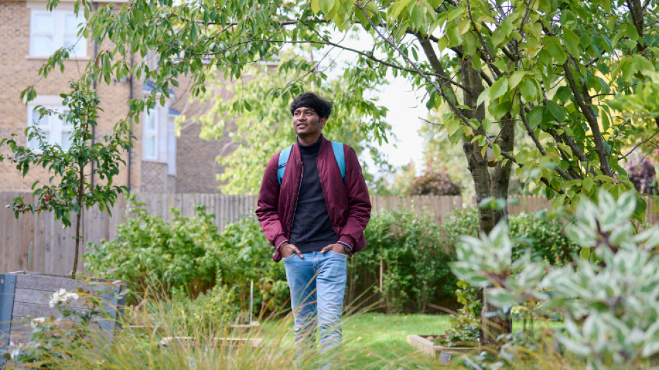 A student wandering around the memorial garden at the Ealing site.