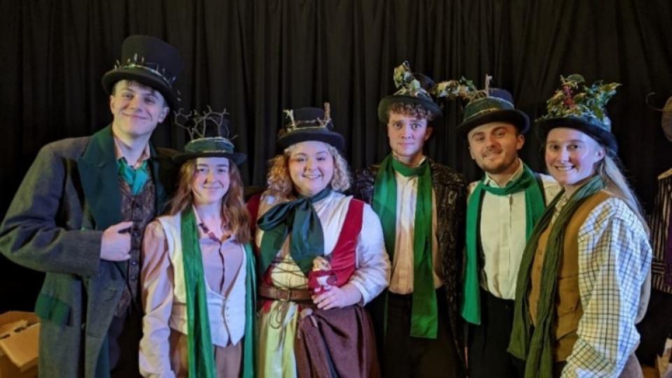 Students from Drama Studio London pose while dressed in their pantomime outfits