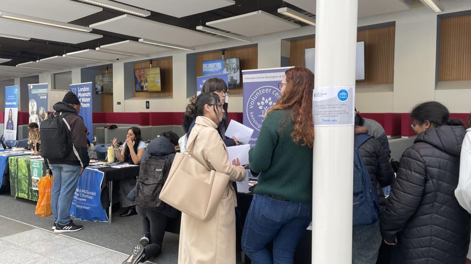Students speak with reps at the University of West London's Volunteering Fair.