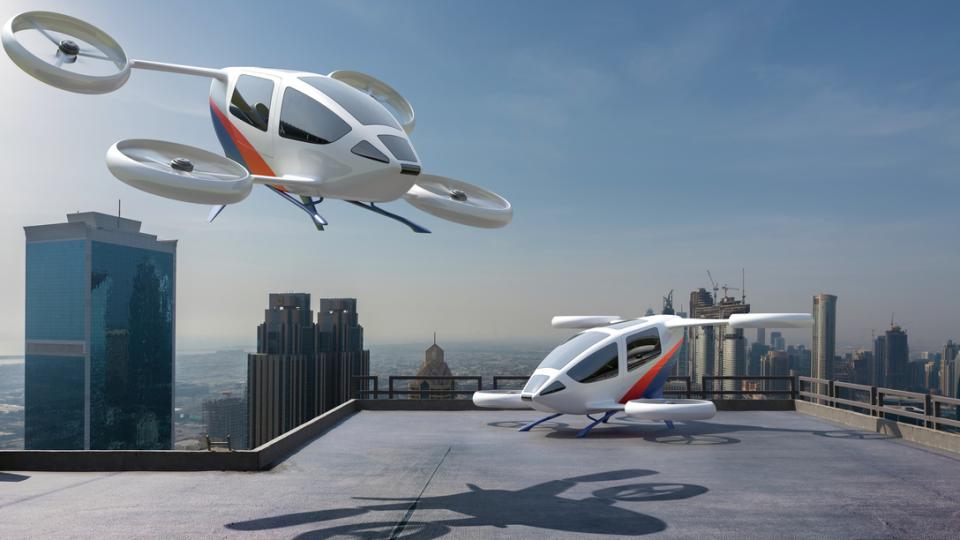 Two eVTOL aircrafts in front of a city skyline