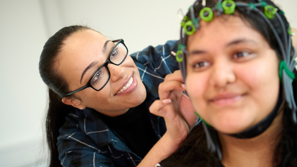 A pair of psychology students experiment with an EEG kit