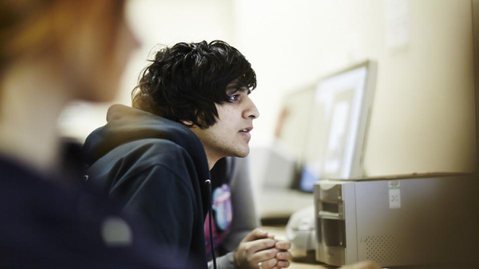 male student in computer lab