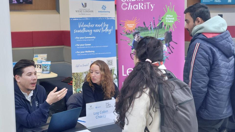 University of West London student volunteers speaking with a charity