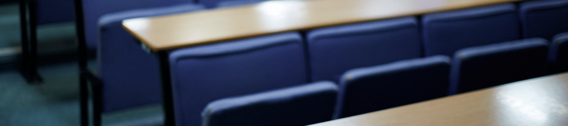 Blue chairs and wooden desks.