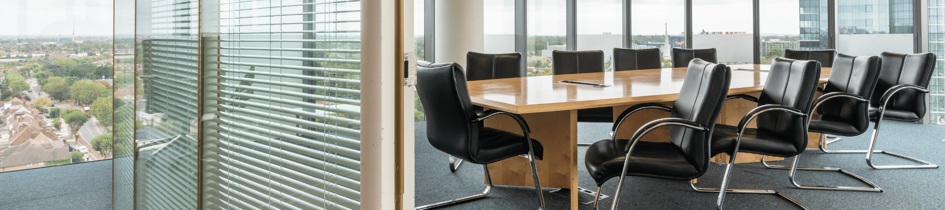 Paragon suite, showing a table, chairs and a view from outside.