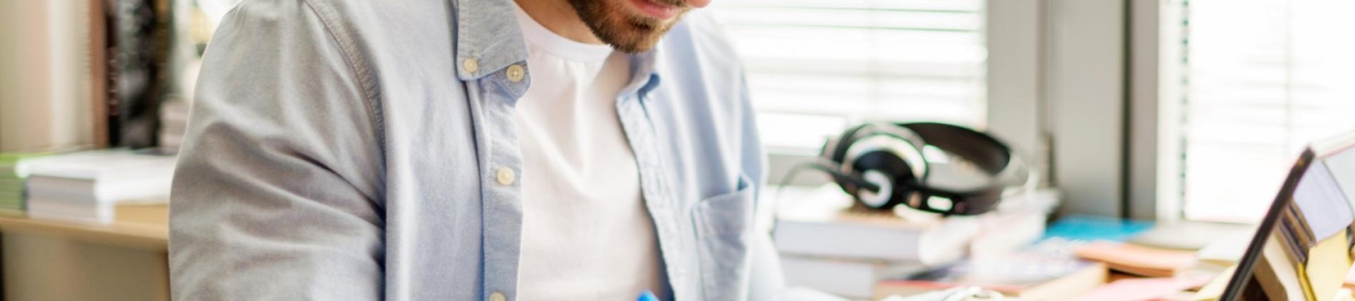 A man working at a laptop in a home study