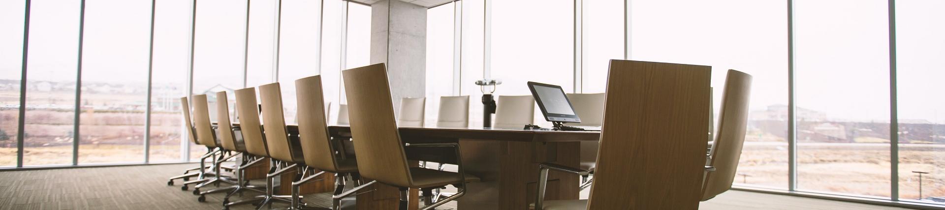 A conference room with several chairs around a table